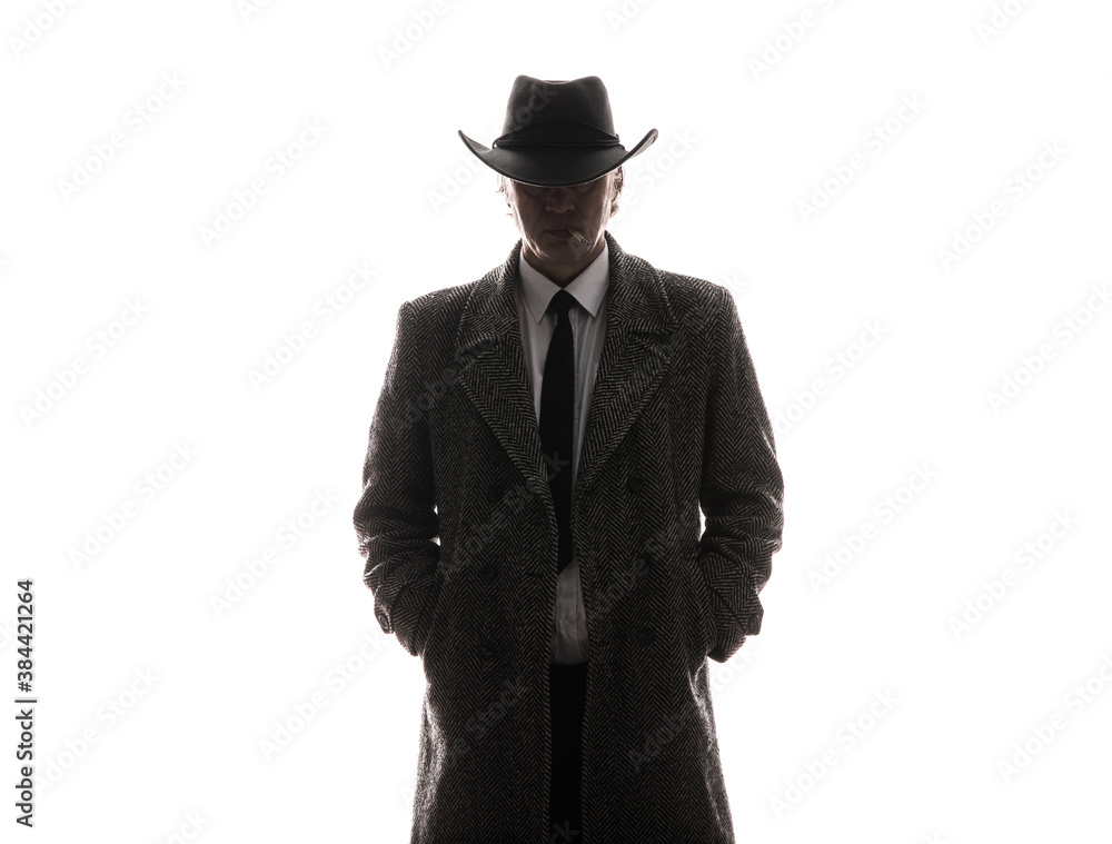 studio portrait of male businessman in gray coat and hat