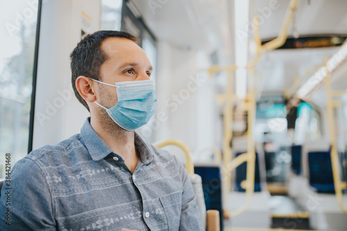 Young man traveling by bus with a mask during pandemics.