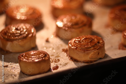 rosy cinnamon rolls on a baking sheet in the oven, sweet rolls in the oven