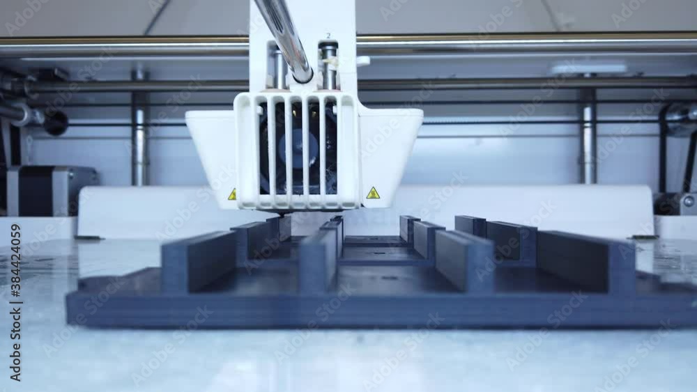 3D printer working. 3D printer, printing with plastic wire filament in additive manufacturing technique. 4K 3D printer working. 3D printer, printing with plastic wire filament in additive manufacturing technique. 4K