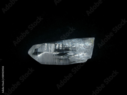 a piece of transparent rock crystal on a black background © Nadezhda