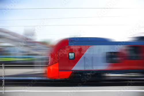 A modern high-speed train moves along the platform. Motion Blur