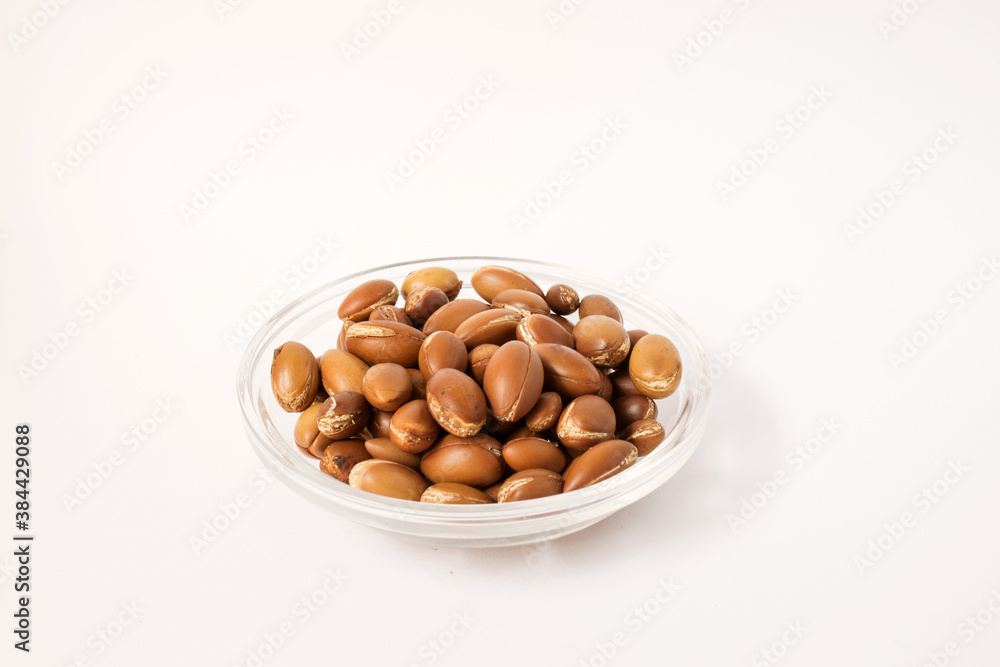 the nuts of the argan tree (Argania spinosa) on a white background. For the production of argan oil the nuts of the argan tree (Argania spinosa) on a white background. For the production of argan oil