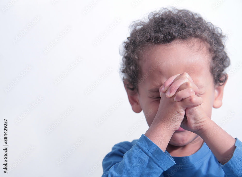 boy praying to God with hands held together with closed eyes on white background stock photo boy praying to God with hands held together with closed eyes on white background stock photo
