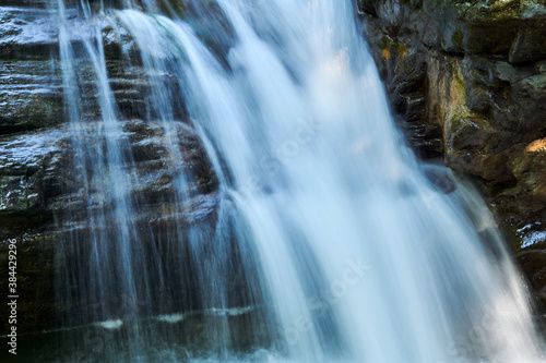 waterfall jets in a mountain stream between rocks  the water is blurred in motion