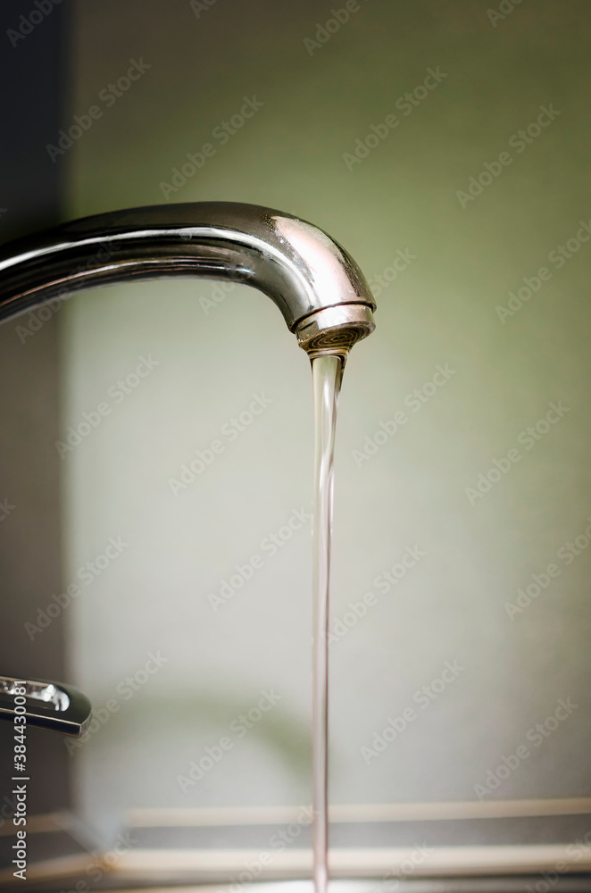 Water flows from the tap. Water supply. Water flows from the tap. Water supply.