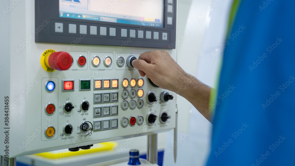 Closeup hand of engineer turning switch on machine panel in factory. Closeup hand of engineer turning switch on machine panel in factory.