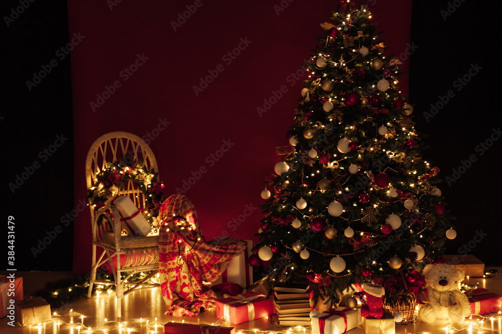 Christmas tree shines lights garlands New Year's Night Red Wall