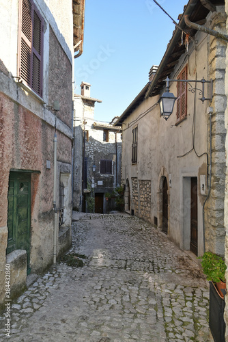 A narrow street between the old houses of Fumone  a medieval village in the province of Frosinone  Italy.