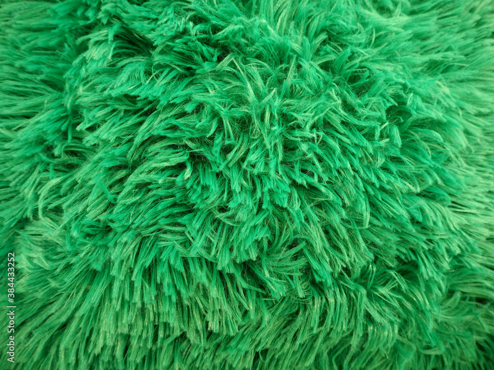 the lint of the green faux fur is close . green fabric texture the lint of the green faux fur is close . green fabric texture
