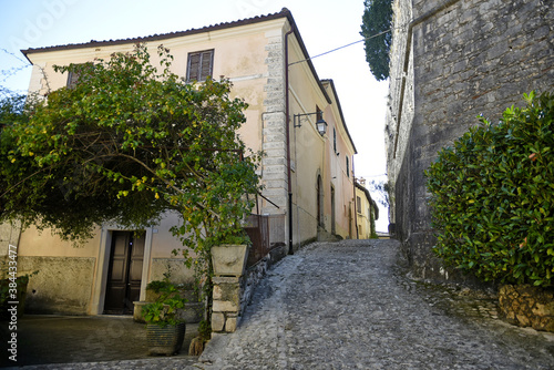 Fototapeta Naklejka Na Ścianę i Meble -  A narrow street between the old houses of Fumone, a medieval village in the province of Frosinone, Italy.