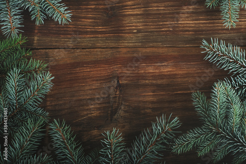 wooden background with Christmas tree branches