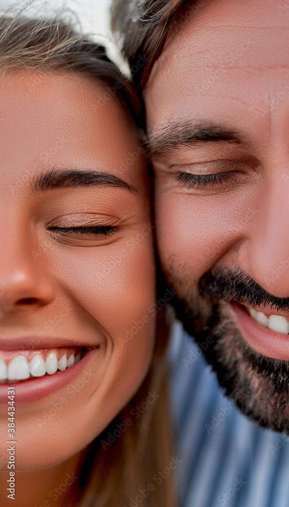 Close-up cropped image of handsome man and attractive woman smiling with closed eyes and having fun. Close-up cropped image of handsome man and attractive woman smiling with closed eyes and having fun.