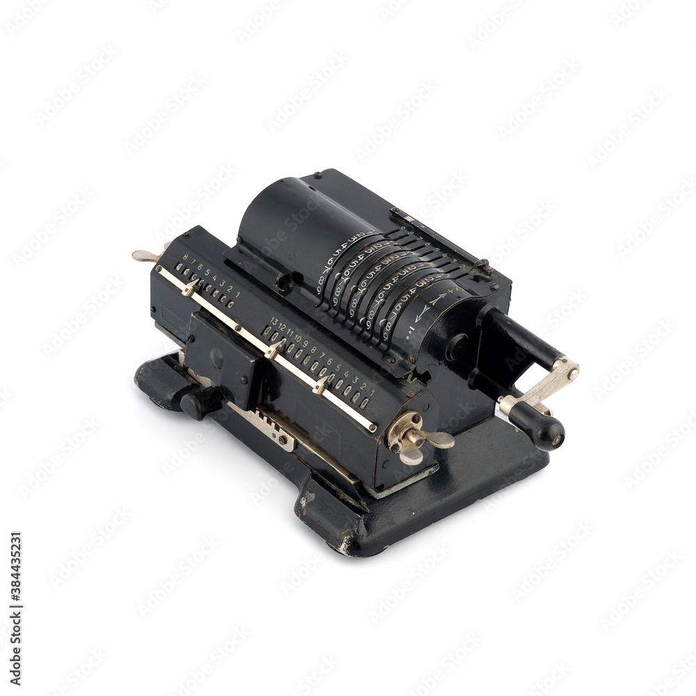 Manual calculating machine (manufactured in 1929) isolated on a white background Manual calculating machine (manufactured in 1929) isolated on a white background