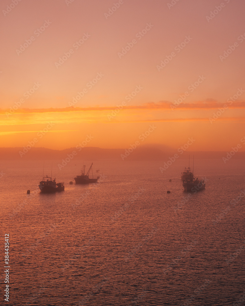 Boats in fog at sunset, in Lubec, Maine