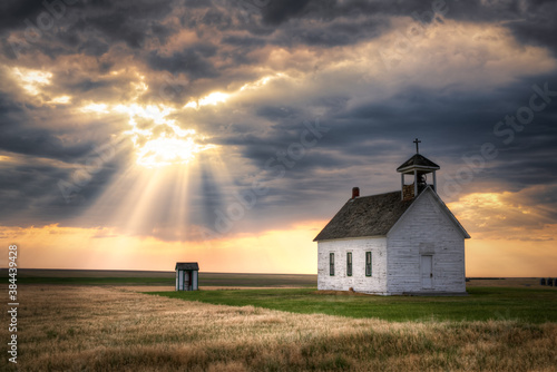An old abandoned Church in the countryside at sunset. The scene is very dramatic and spiritual. 