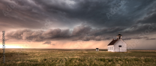 Old abandoned church in the countryside of Colorado under a dramatic sky.