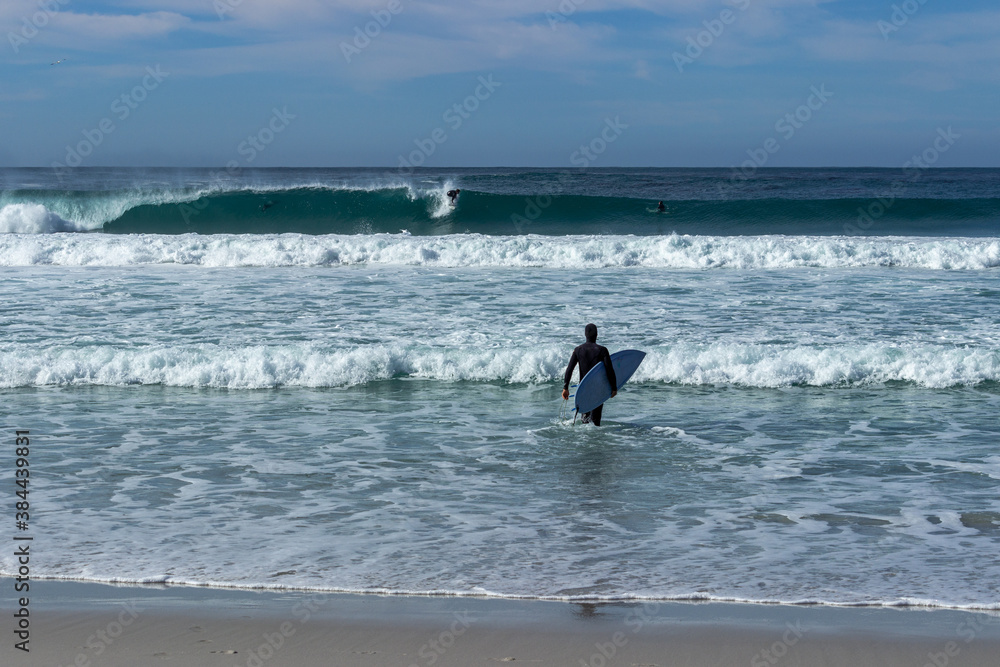 Surfer near the town of Carmel on the pacific coast of California
