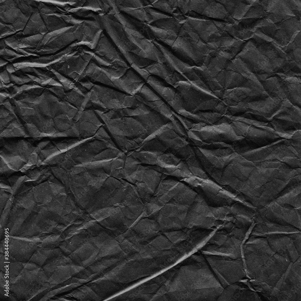 Fototapeta premium Black vintage and old looking crumpled paper background. Retro cardboard texture. Grunge paper for drawing. Ancient book page. Present wrapping.