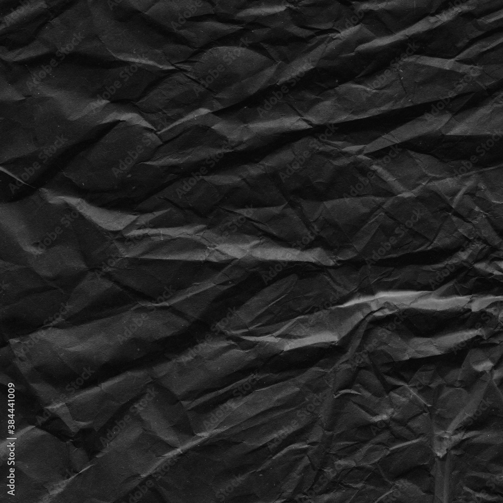 Fototapeta premium Black vintage and old looking crumpled paper background. Retro cardboard texture. Grunge paper for drawing. Ancient book page. Present wrapping.