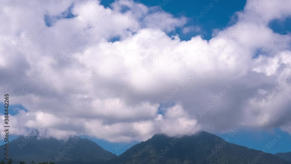 White clouds in blue sky above mountains, timelapse. Climate, weather, clean air concept White clouds in blue sky above mountains, timelapse. Climate, weather, clean air concept