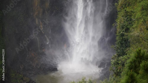 Slow motion shot of water from Sipiso Piso Waterfall in North Sumatra, Indonesia hitting lake at the bottom photo