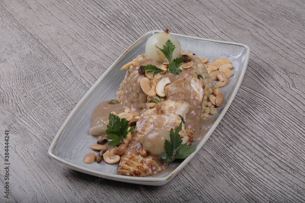 Fish fillet With the grains Dough sauce And chickpeas Decorated With green parsley And cooked onions Fish fillet With the grains Dough sauce And chickpeas Decorated With green parsley And cooked onions