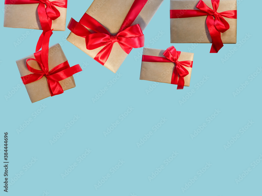 Gift boxes with red ribbon, copy space on a light blue background. Sales concepts, discount price, Christmas gifts and shopping, Greeting card for Christmas, Valentine's Day or New Year Gift boxes with red ribbon, copy space on a light blue background. Sales concepts, discount price, Christmas gifts and shopping, Greeting card for Christmas, Valentine's Day or New Year