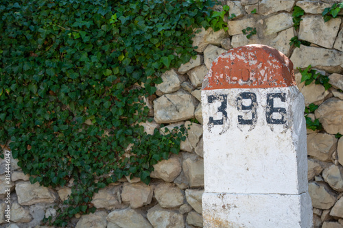 Old milestones exposed on the Bailen-Motril road (N-323) as it passes through La Cerradura de Pegalajar (Jaen-Spain) photo