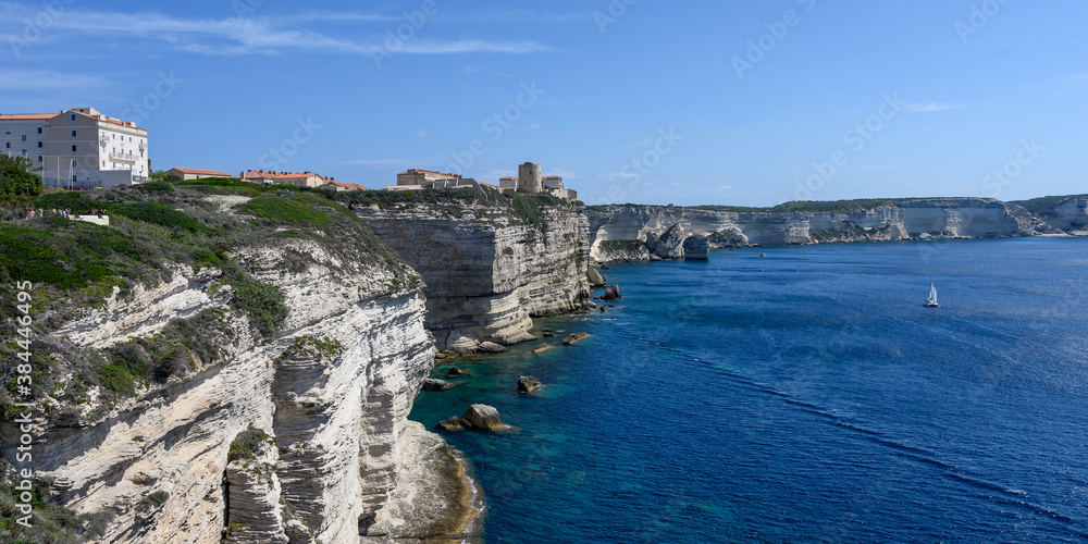 Panorama of the white limestone cliffs and Bonifacio Corsica, sea and blue sky in the background, copy space