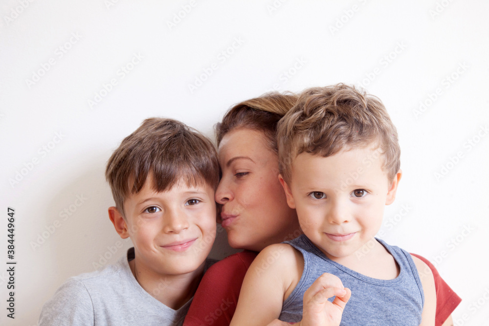 Portrait of happy mother with cute kids boy on a light background. Happy family concept. Portrait of happy mother with cute kids boy on a light background. Happy family concept.