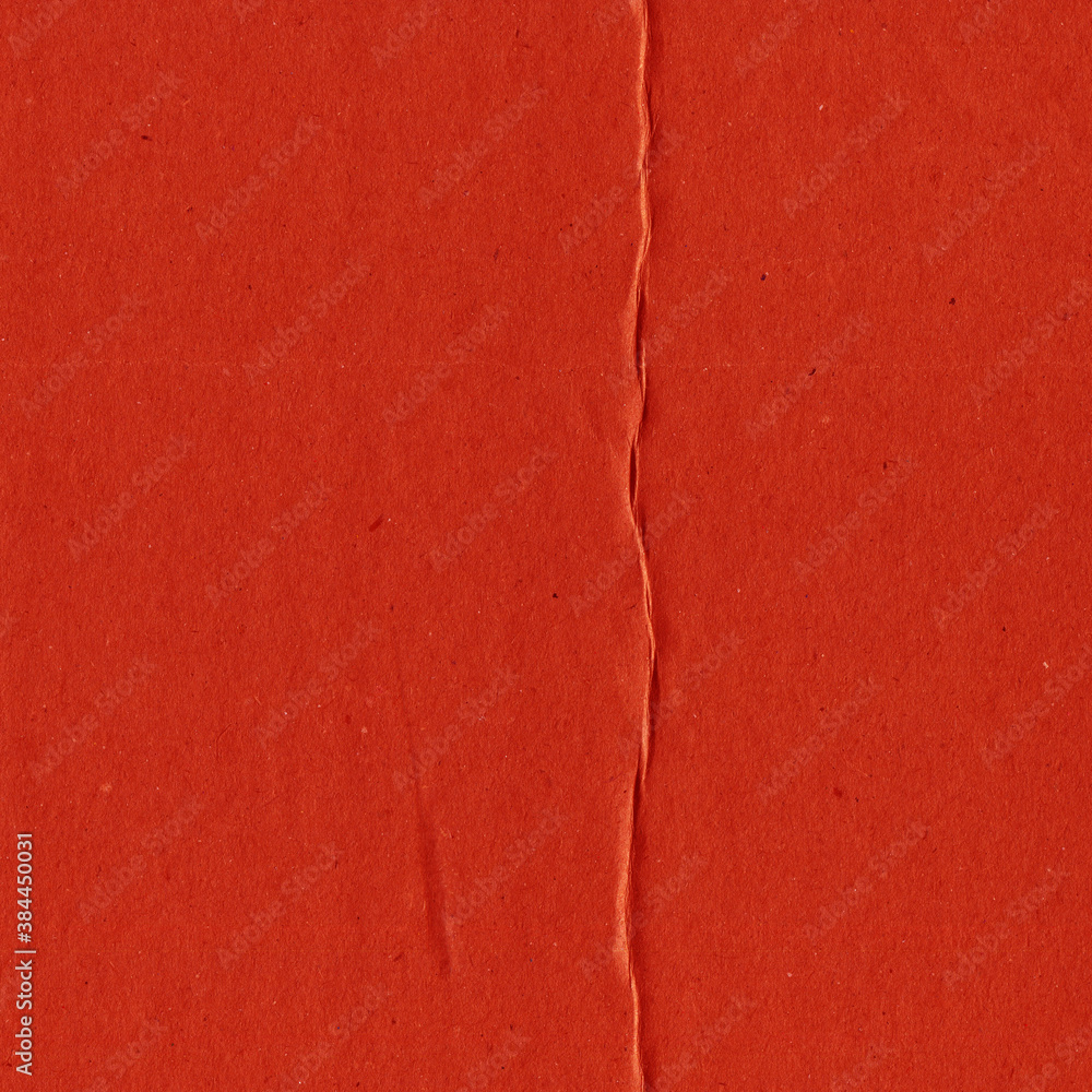 Fototapeta premium A red vintage rough sheet of carton. Recycled environmentally friendly cardboard paper texture. Simple and bright minimalist papercraft background. 
