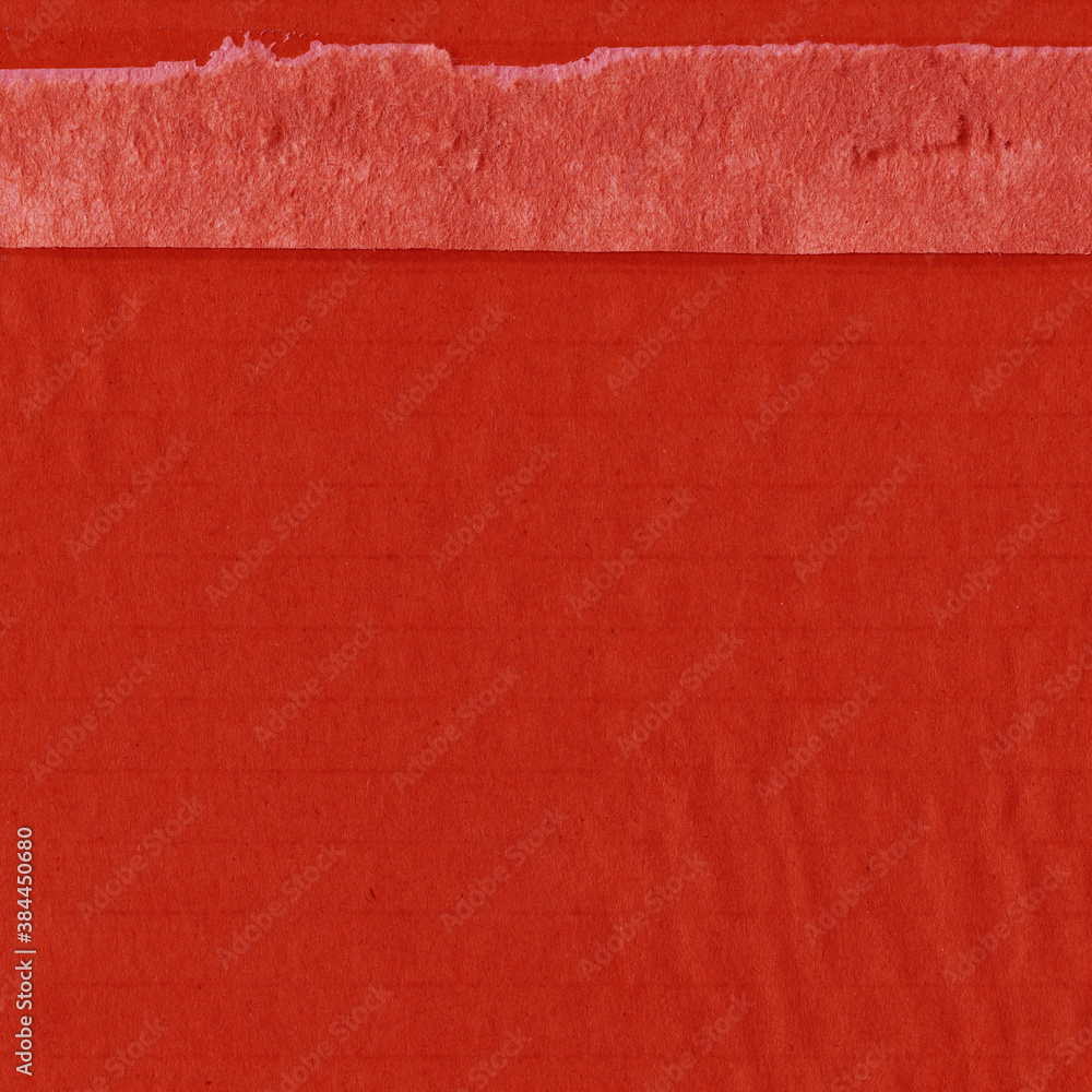 Fototapeta premium A red vintage rough sheet of carton. Recycled environmentally friendly cardboard paper texture. Simple and bright minimalist papercraft background.