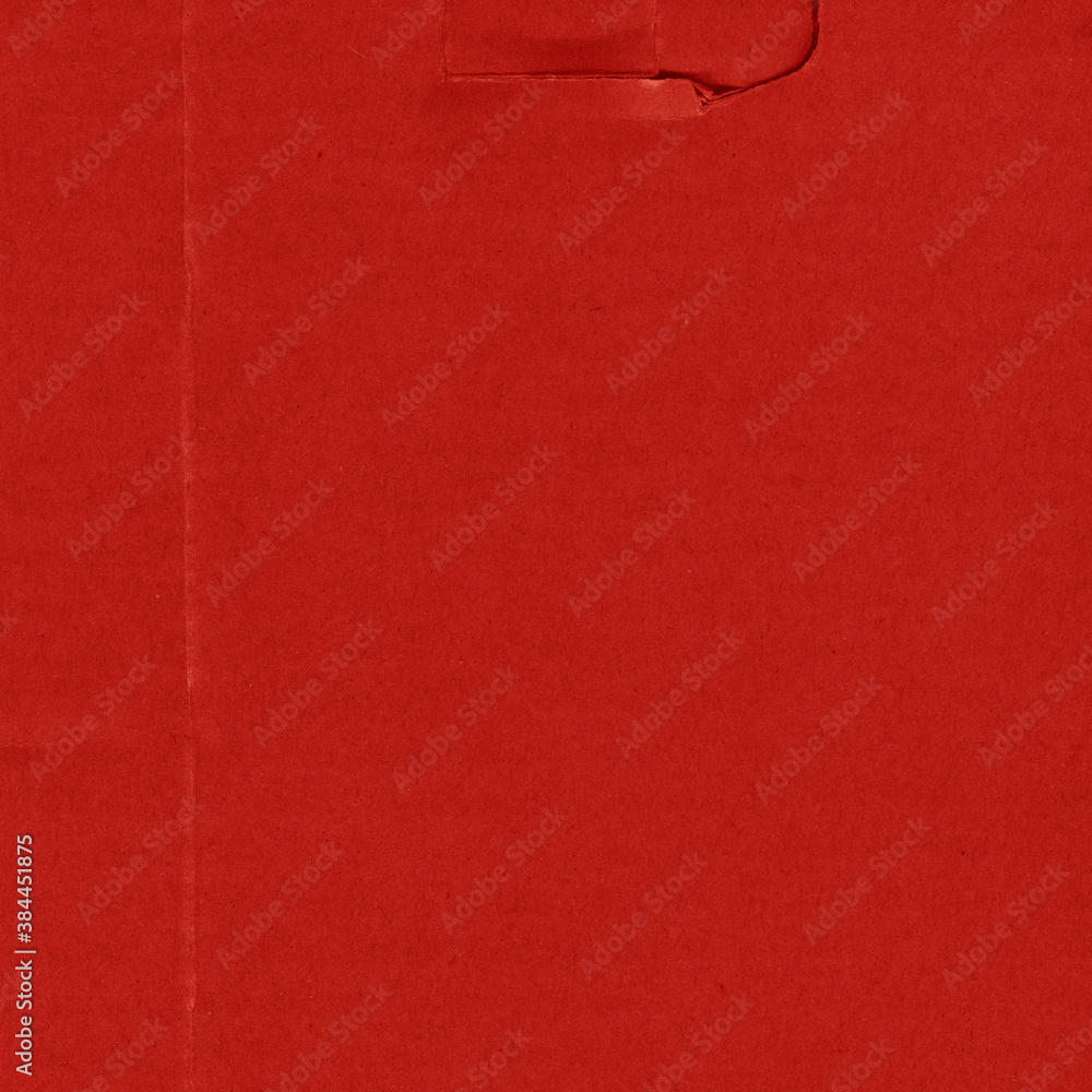Fototapeta premium A red vintage rough sheet of carton. Recycled environmentally friendly cardboard paper texture. Simple and bright minimalist papercraft background.