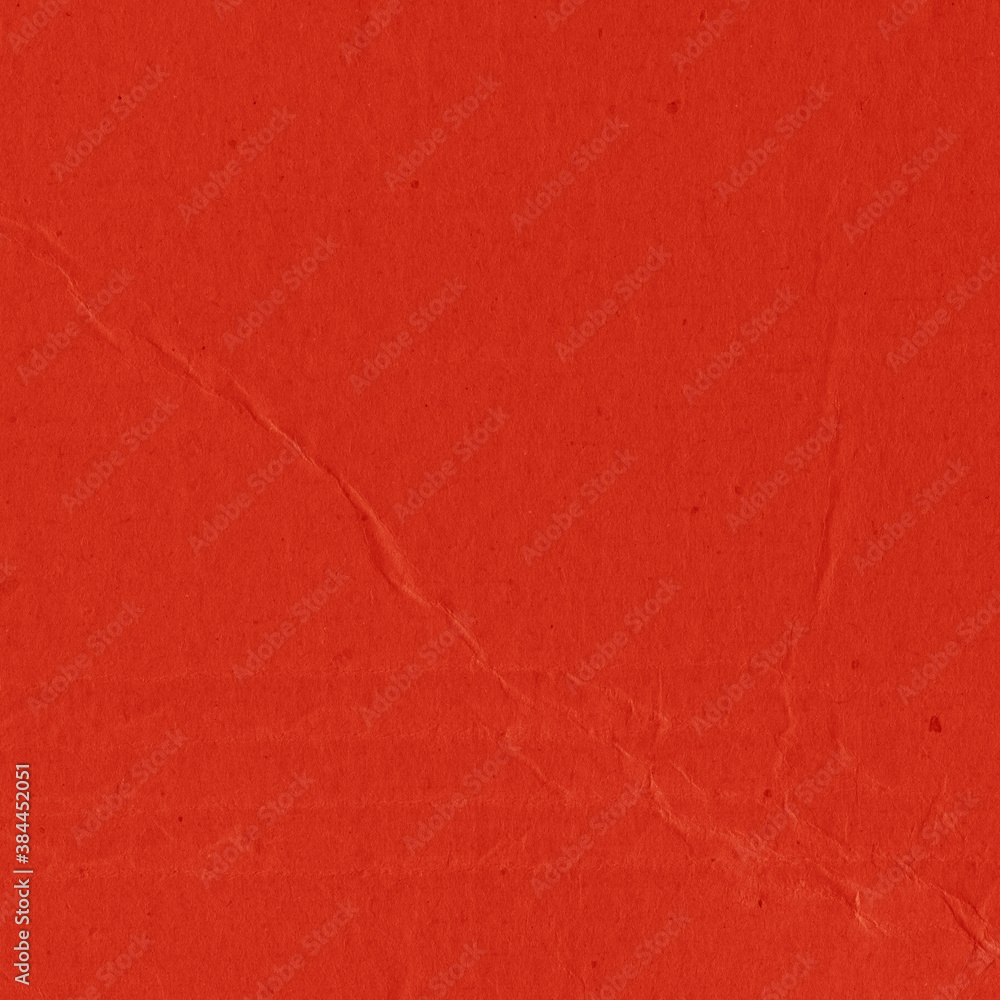 Fototapeta premium A red vintage rough sheet of carton. Recycled environmentally friendly cardboard paper texture. Simple and bright minimalist papercraft background.