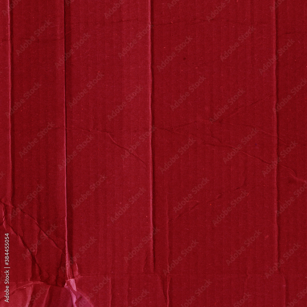 Fototapeta premium A red vintage rough sheet of carton. Recycled environmentally friendly cardboard paper texture. Simple and bright minimalist papercraft background.