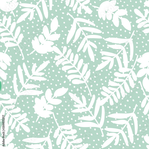 Pastel doodle seamless pattern of hand drawn branch silhouette with leaves on dotted background design