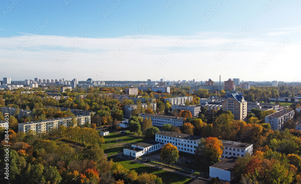 Top view of a beautiful autumn park in the city with houses