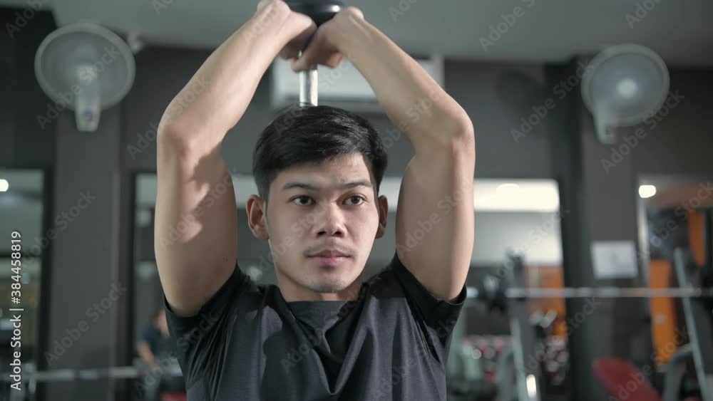 Fitness concept. Young asian men lifting dumbbells in the gym. 4k Resolution. Fitness concept. Young asian men lifting dumbbells in the gym. 4k Resolution.