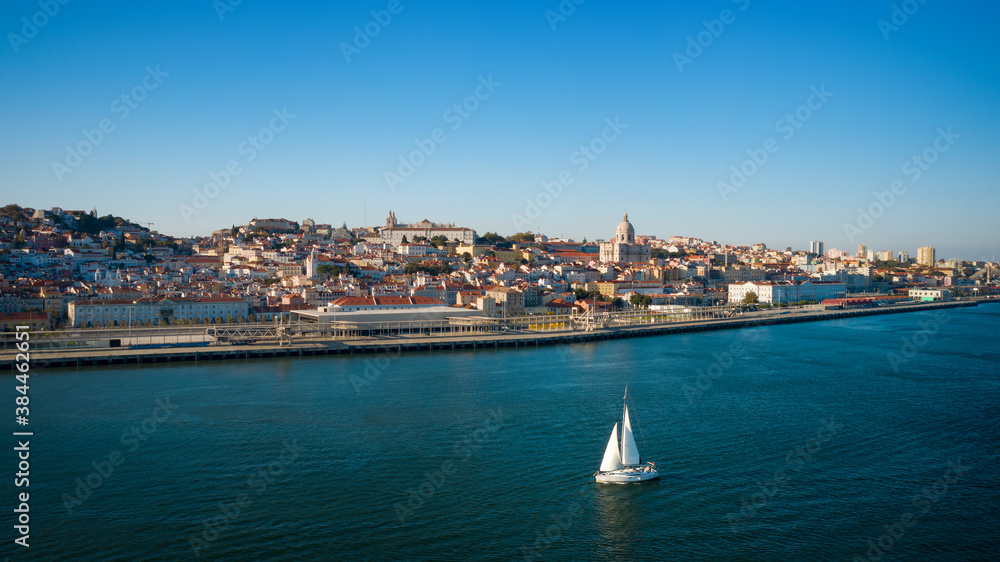 Aerial view of Lisbon city and Tagus river with sailing yacht