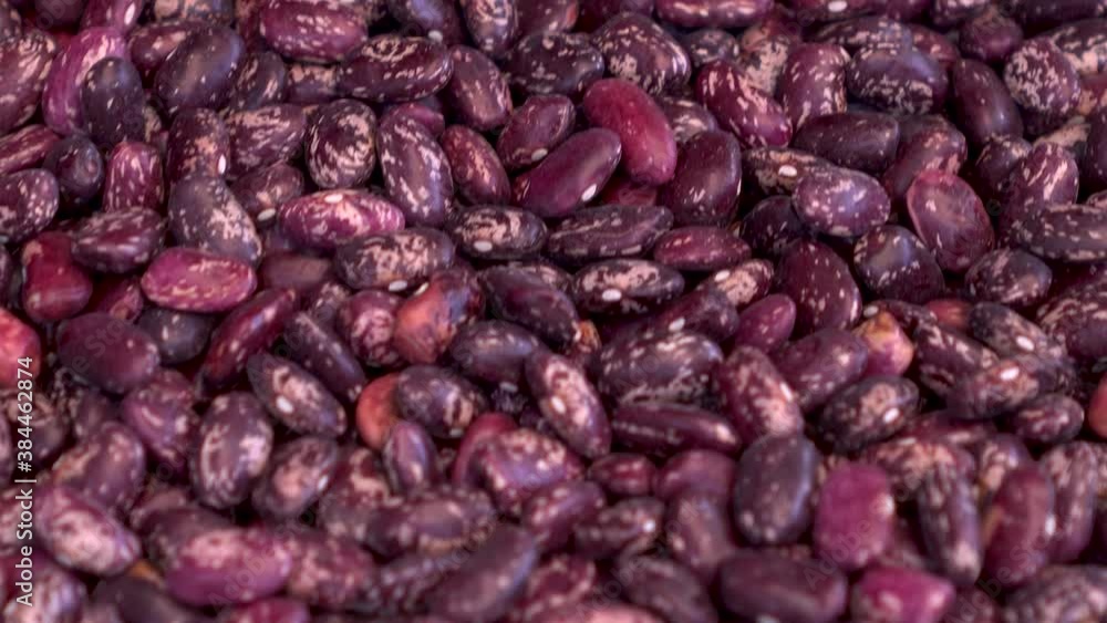 A pile of red beans on the market close-up. The camera moves. A pile of red beans on the market close-up. The camera moves.