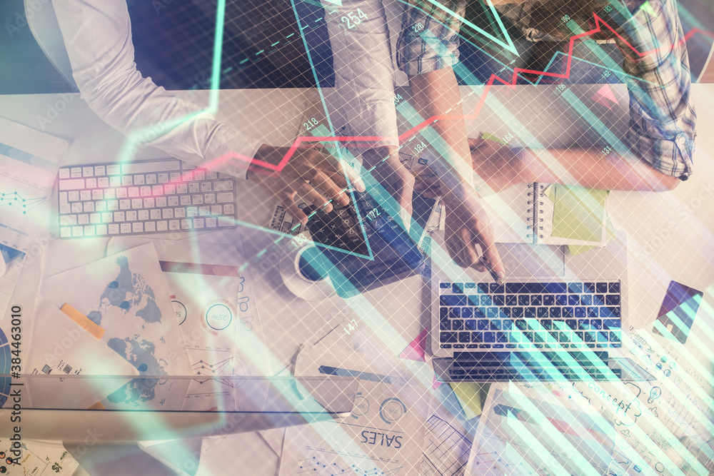Double exposure of man and woman working together and financial graph hologram drawing. market analysis concept. Computer background. Top View. Double exposure of man and woman working together and financial graph hologram drawing. market analysis concept. Computer background. Top View.
