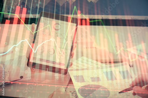 Fototapeta Naklejka Na Ścianę i Meble -  Double exposure of man's hands holding and using a digital device and forex graph drawing. Financial market concept.