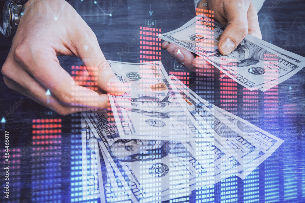 Multi exposure of financial graph drawing hologram and USA dollars bills and man hands. Analysis concept. Multi exposure of financial graph drawing hologram and USA dollars bills and man hands. Analysis concept.
