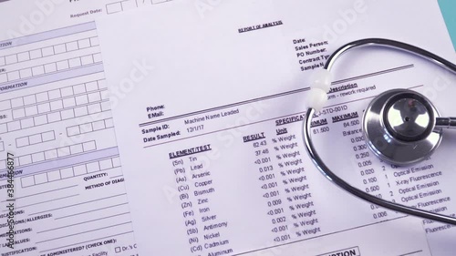 Prior authorization form, report of analysis form, x-ray picture and prescription blank next to the stethoscope and pen