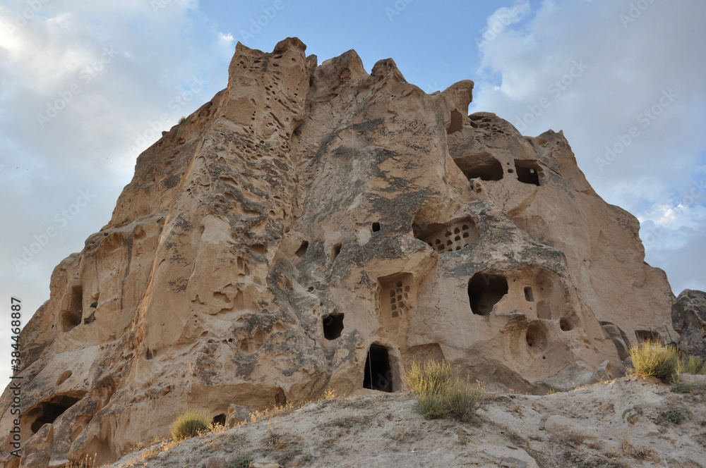Exterior view of Uchisar Castle in Cappadocia, Turkey near sunset Exterior view of Uchisar Castle in Cappadocia, Turkey near sunset