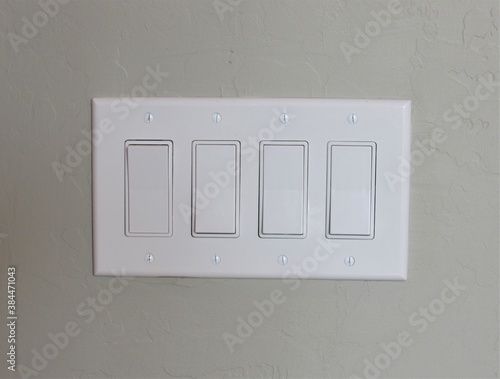 White modern light switch set on a painted interior wall