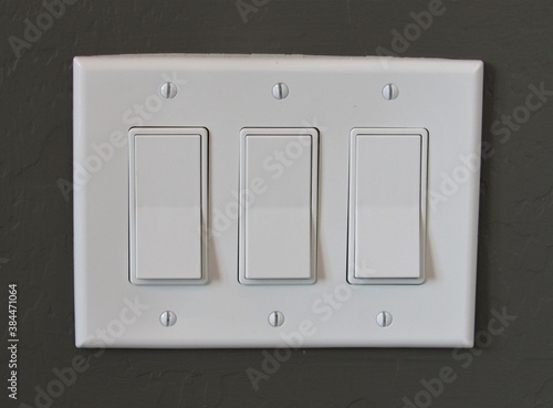 White modern light switch set on a painted interior wall