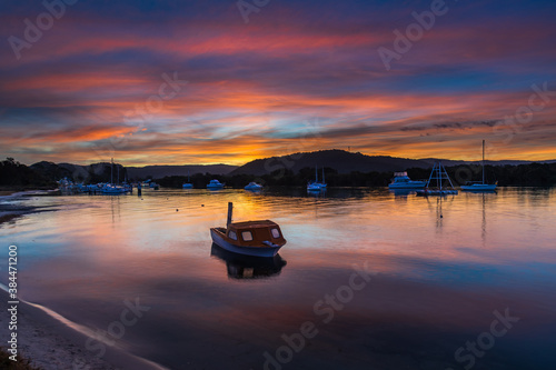 Sunset at the waterfront with high cloud and boats
