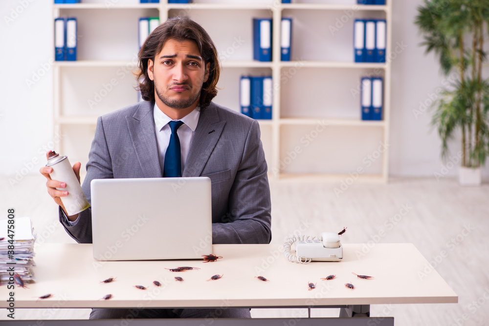 Young male employee and too many cockroaches in the office Young male employee and too many cockroaches in the office